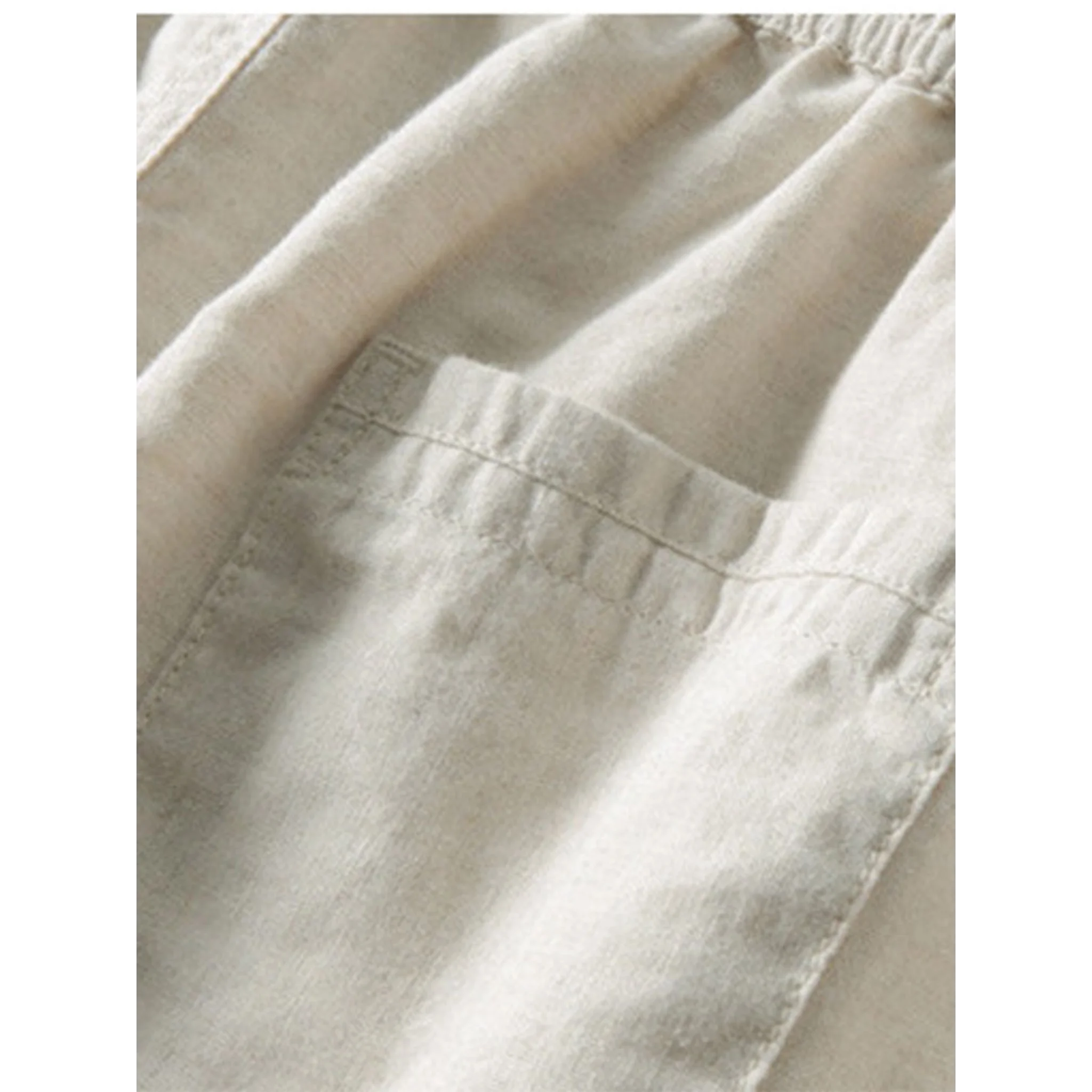 Man in white and beige geometry textured Cuban shirt and linen pants in outdoor lifestyle setting