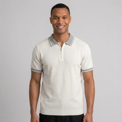 Man wearing a white color block knit polo shirt with lapel collar front view on plain background