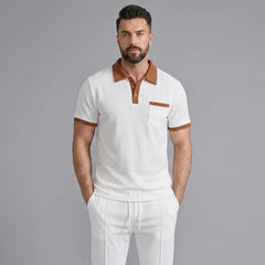 Man wearing white color block waffle polo and straight leg pants in outdoor lifestyle setting