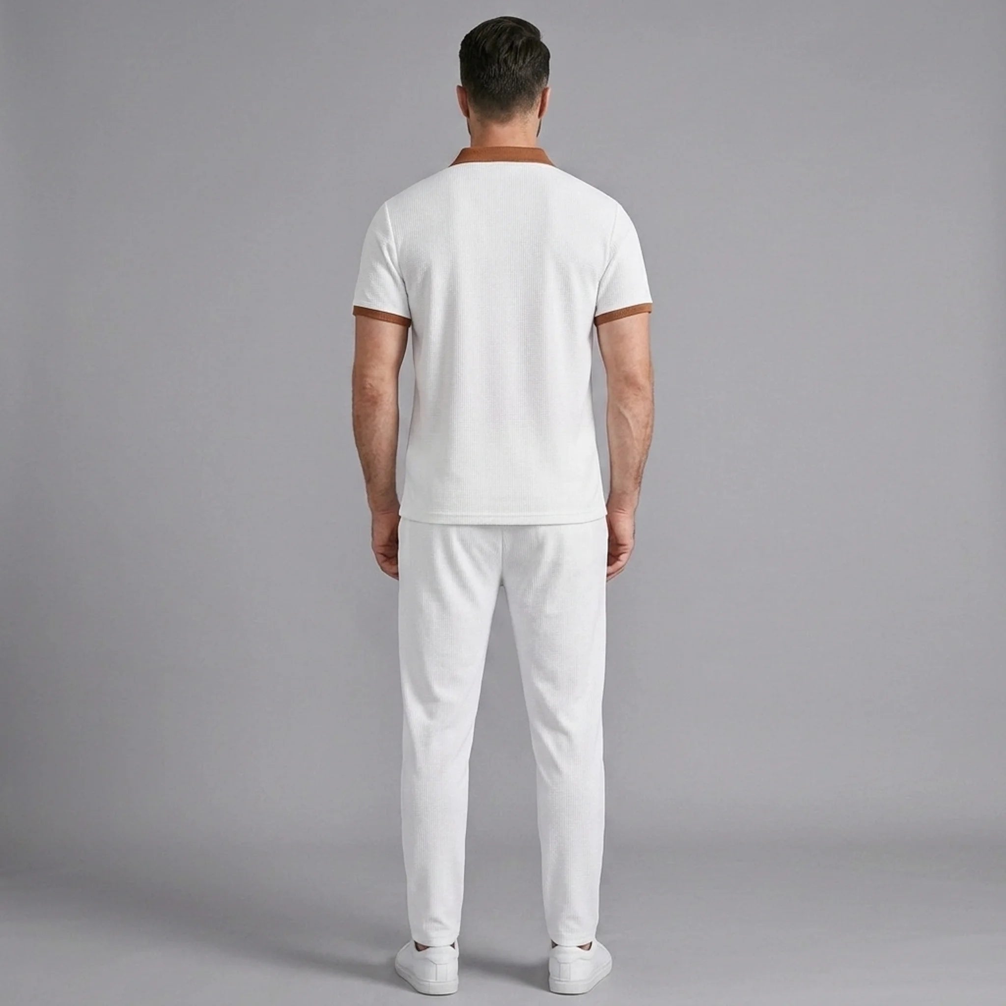 Side view of man in white color block waffle polo and straight leg pants