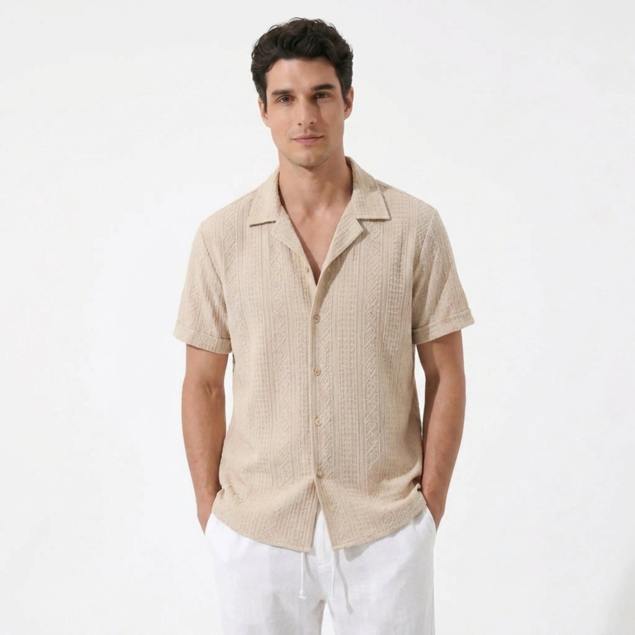 Man wearing white geometric jacquard button up shirt and straight leg linen pants front view