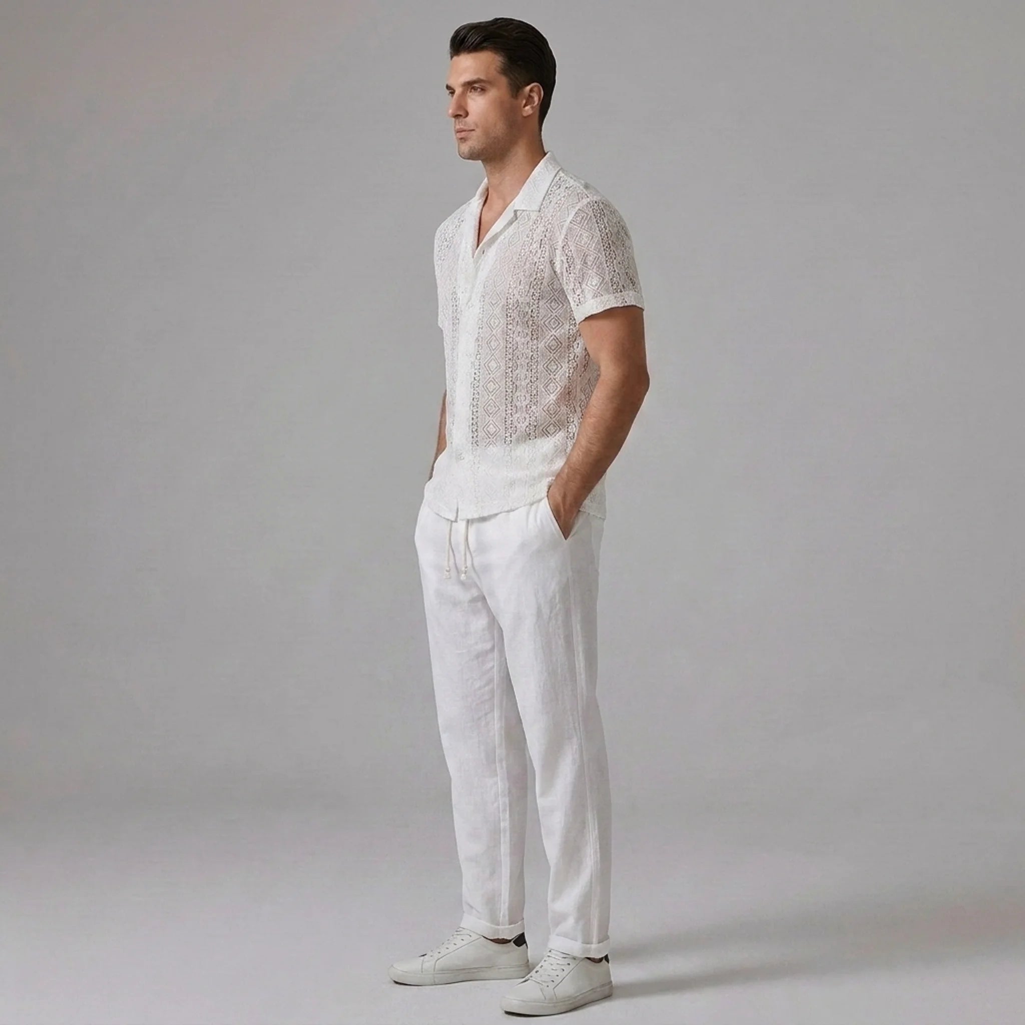 Back view of man wearing white geometry textured Cuban shirt and straight leg linen pants