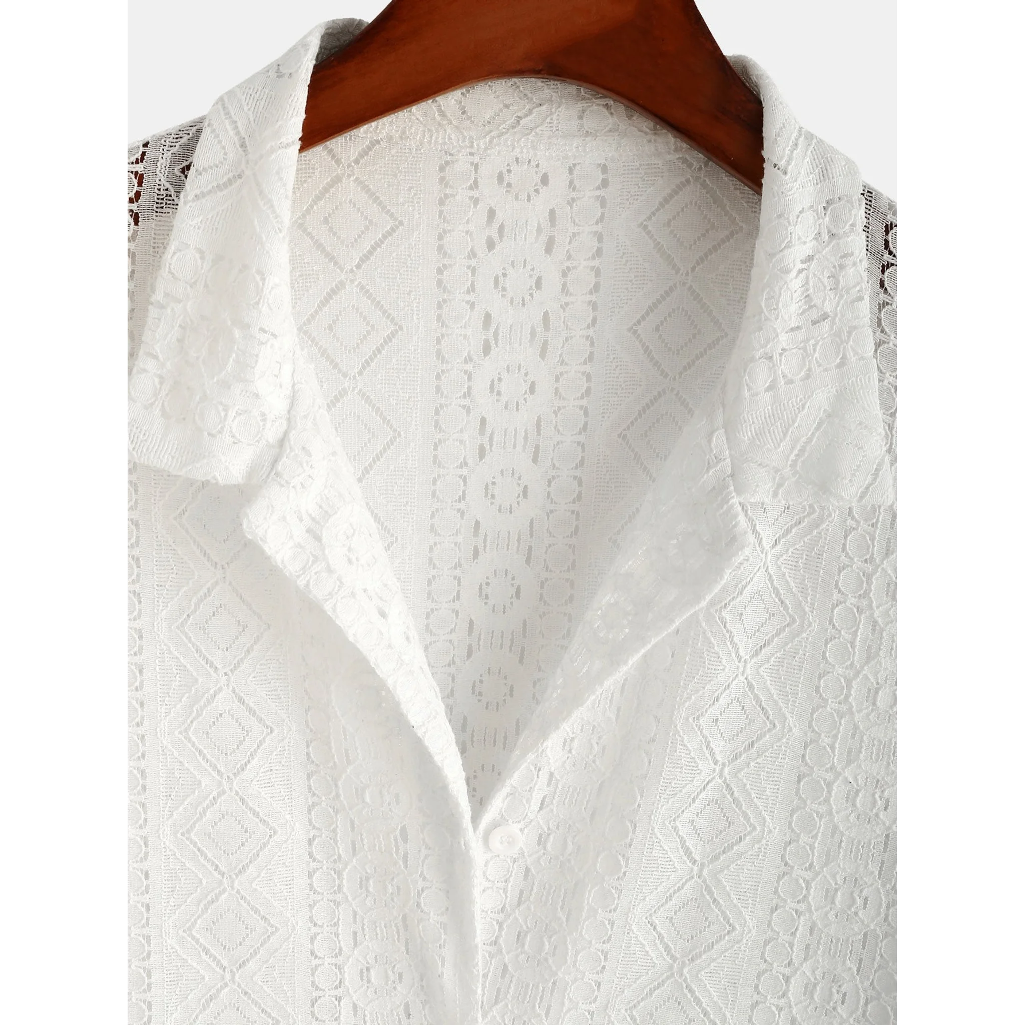 Man in white geometry textured Cuban shirt and linen pants walking in sunny outdoor summer scene