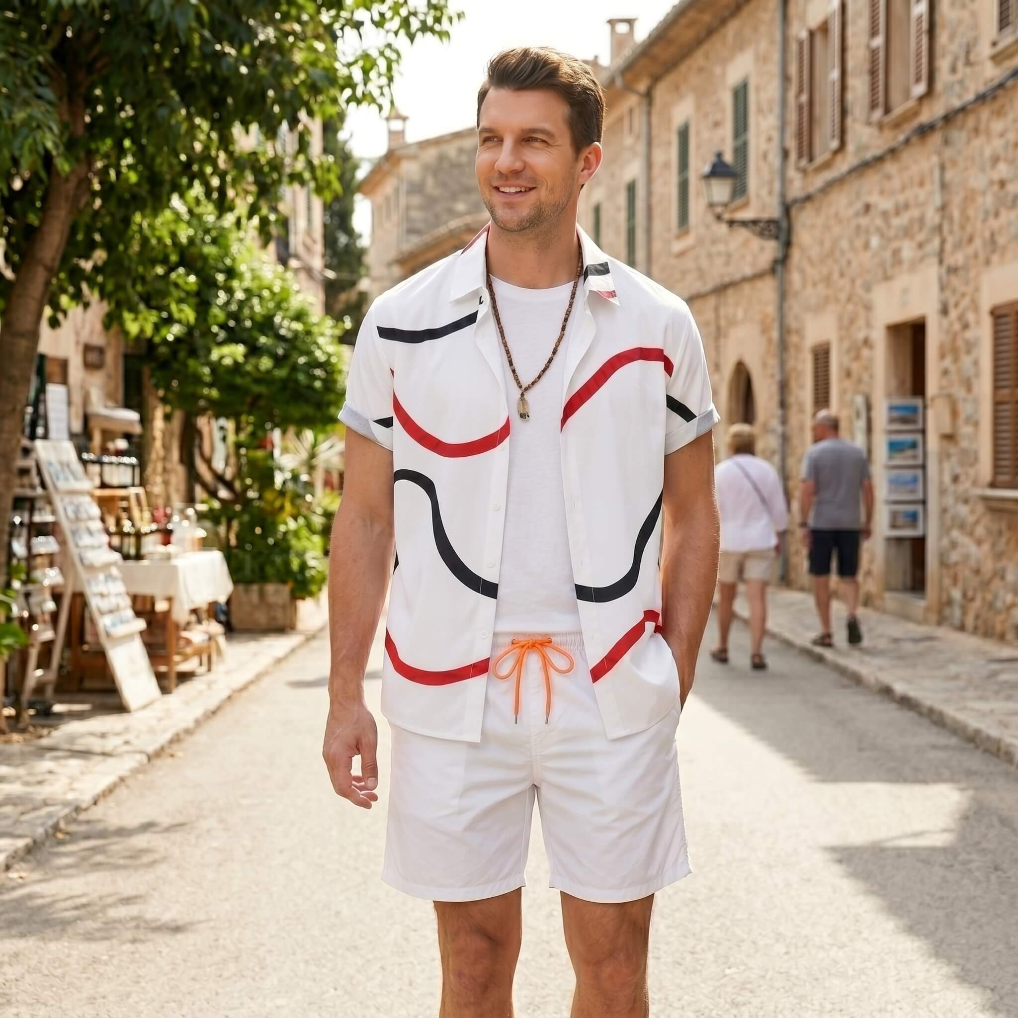 Man wearing white line print button up shirt and swim shorts in outdoor lifestyle setting