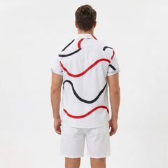 Side view of man in white line print button up shirt and swim shorts on plain background