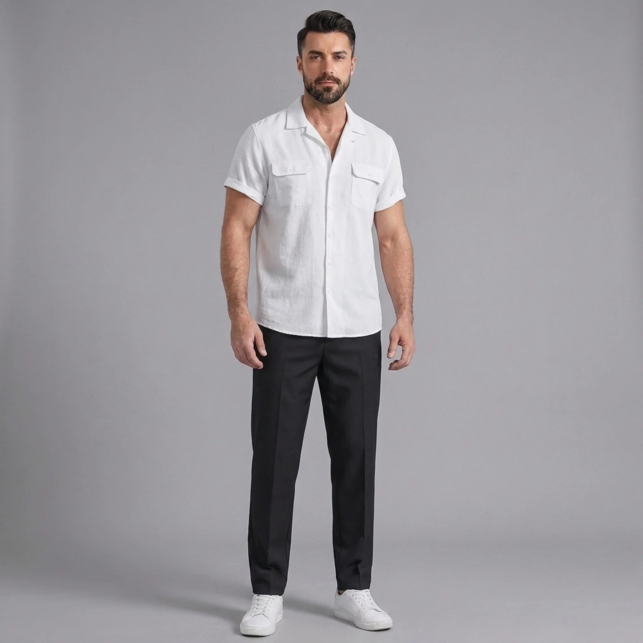 Man wearing a white linen Cuban collar shirt and slim fit tapered trousers front view on plain background