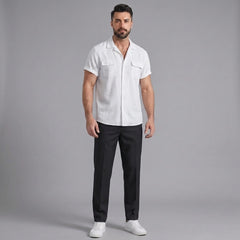 Man wearing a white linen Cuban collar shirt and slim fit tapered trousers front view on plain background