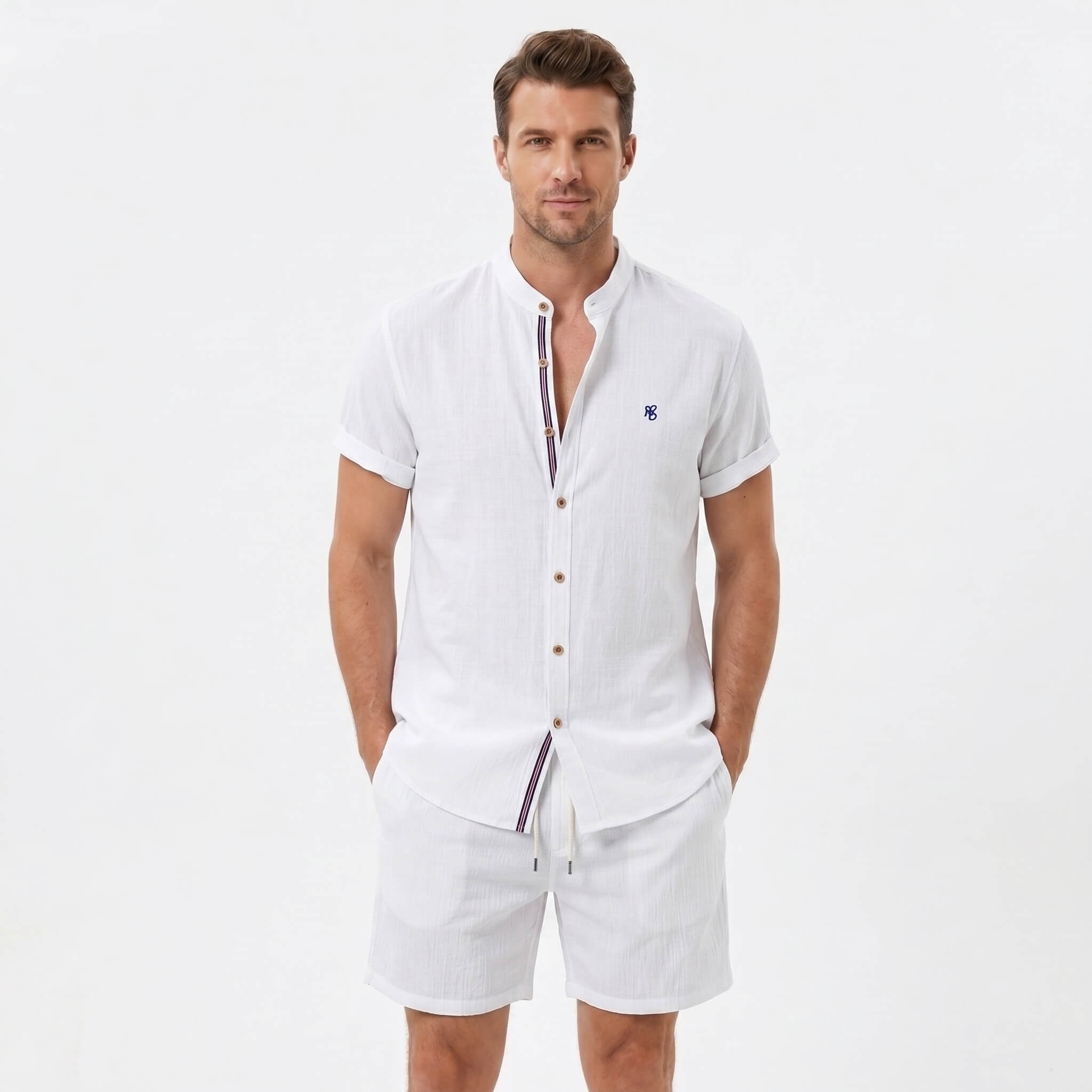 Man wearing a white linen look stand collar shirt and crinkle textured drawstring shorts front view