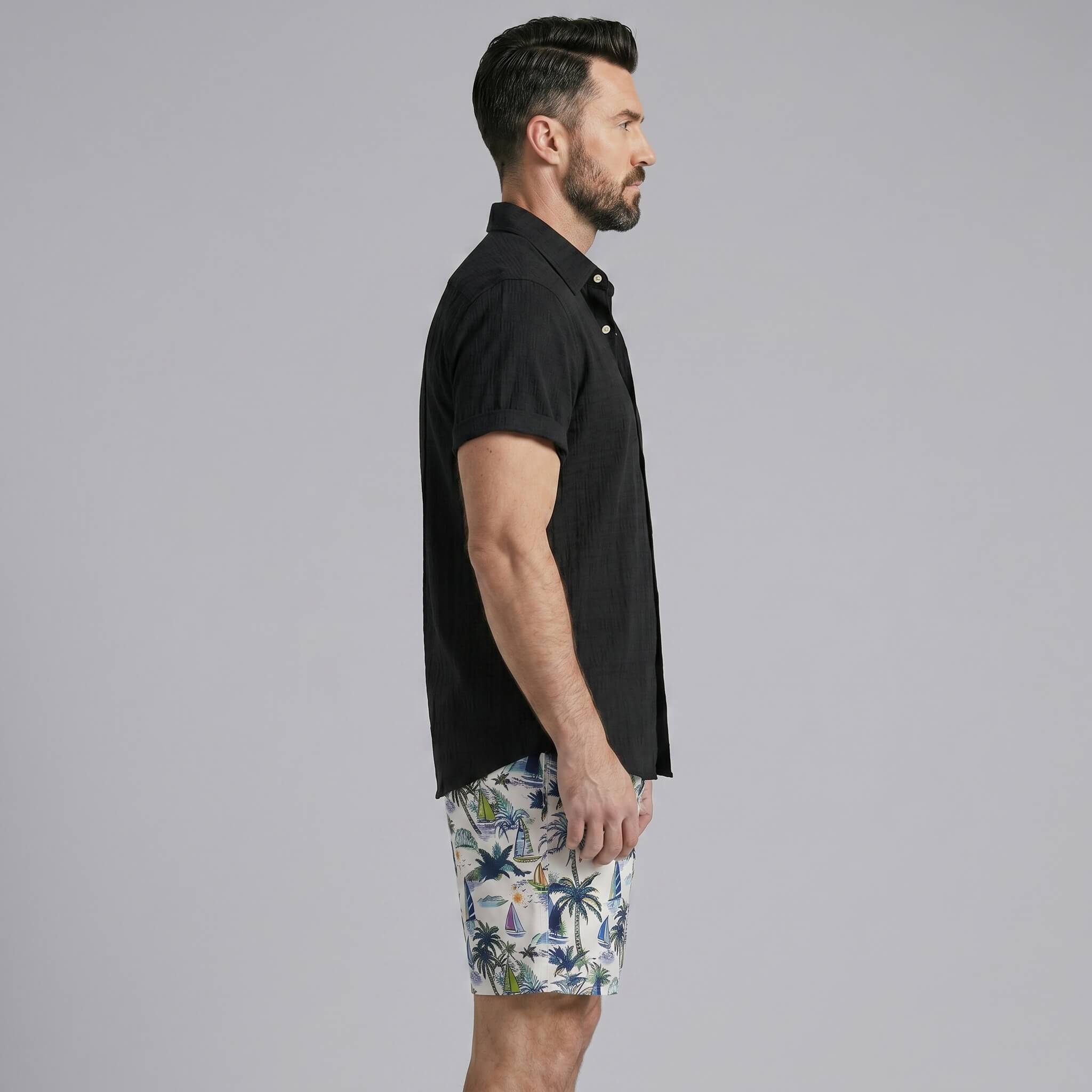Man wearing a white linen rayon button up shirt and white palm tree print swim shorts front view