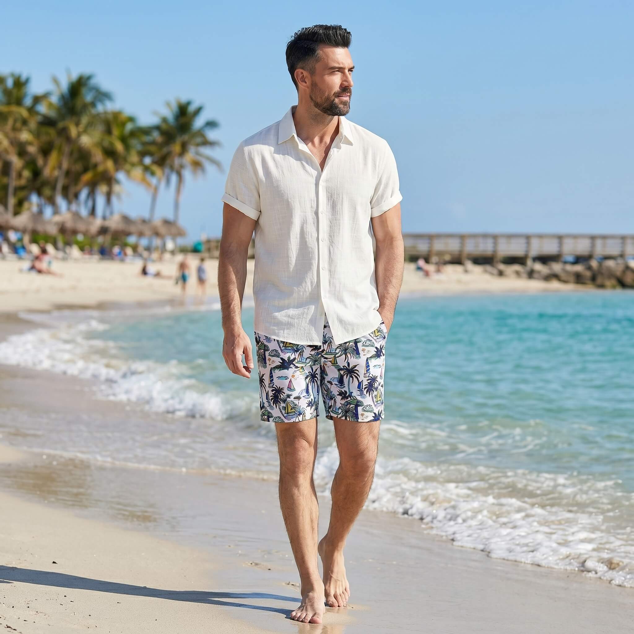 Man in white linen rayon shirt and white palm tree swim shorts walking in sunny outdoor scene