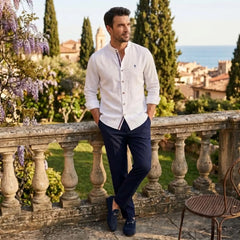 MannerCo white linen stand collar shirt and navy slim fit tapered trousers 2-piece set worn outdoors