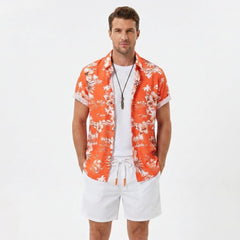 Man wearing a white palm tree tropical print button up shirt and swim shorts front view on plain background