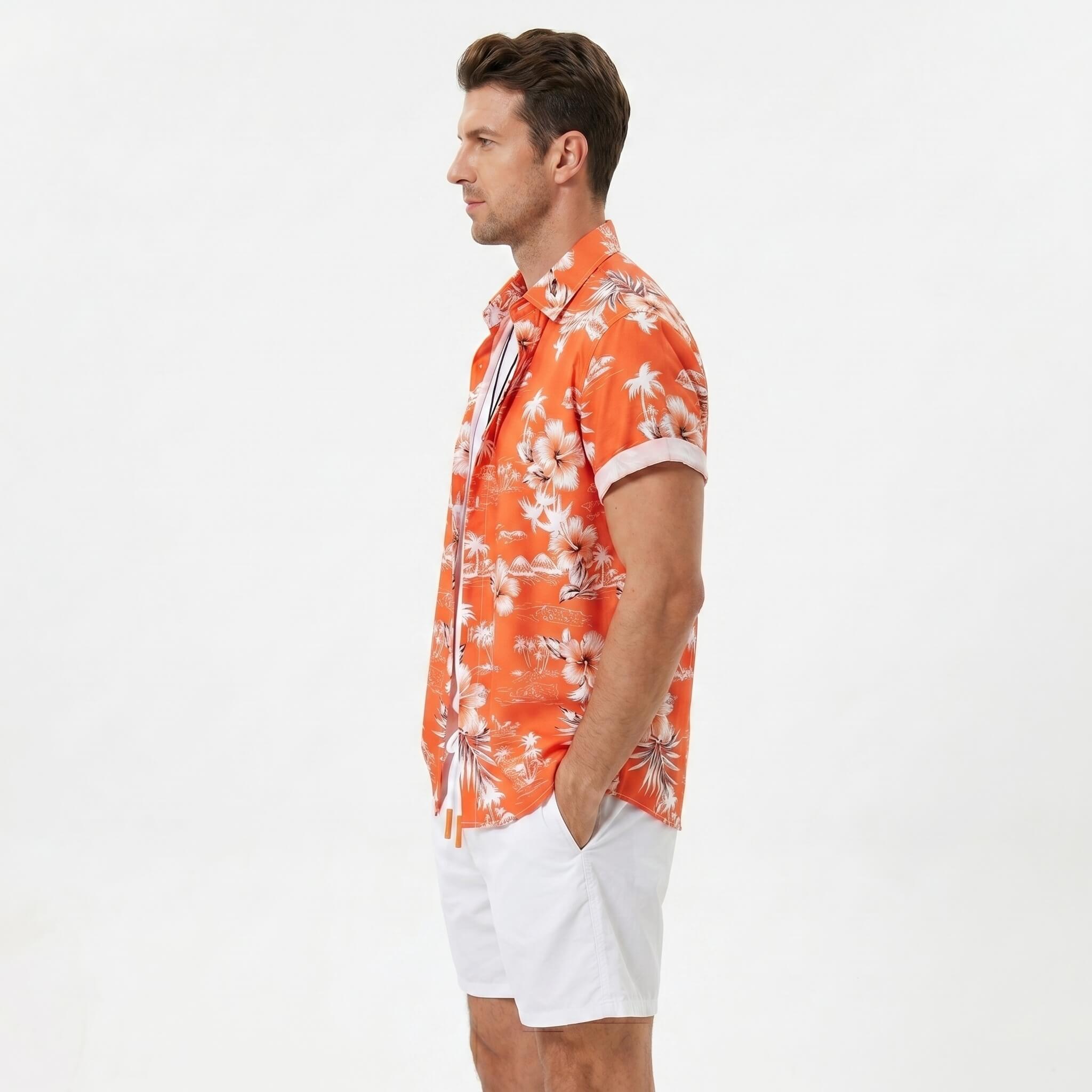 Man wearing white palm tree tropical print shirt and swim shorts walking in sunny outdoor setting