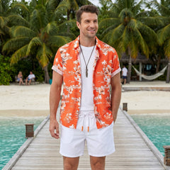 Man wearing white palm tree tropical print shirt and swim shorts at resort poolside lifestyle scene