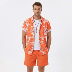 Man in white palm tree tropical print shirt and swim shorts in tropical outdoor vacation setting