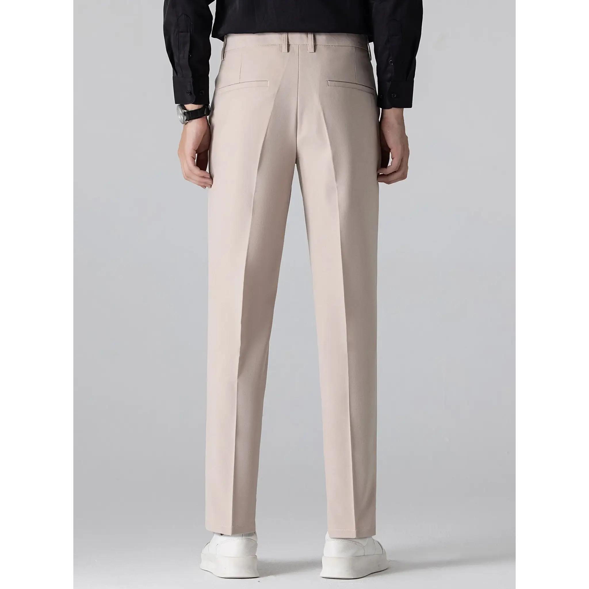 MannerCo white slim fit tapered trousers back view with black shirt and white sneakers