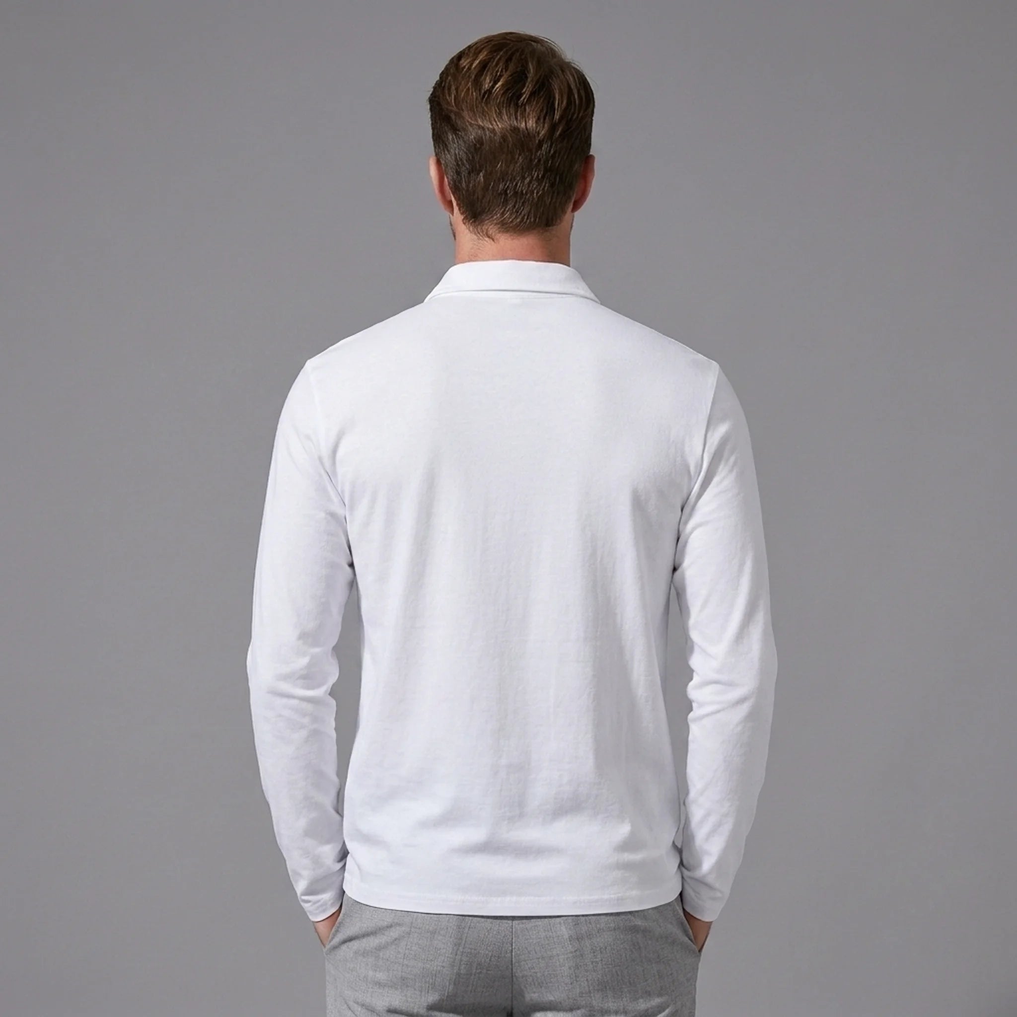 Back view of man wearing white solid long sleeve cotton polo shirt