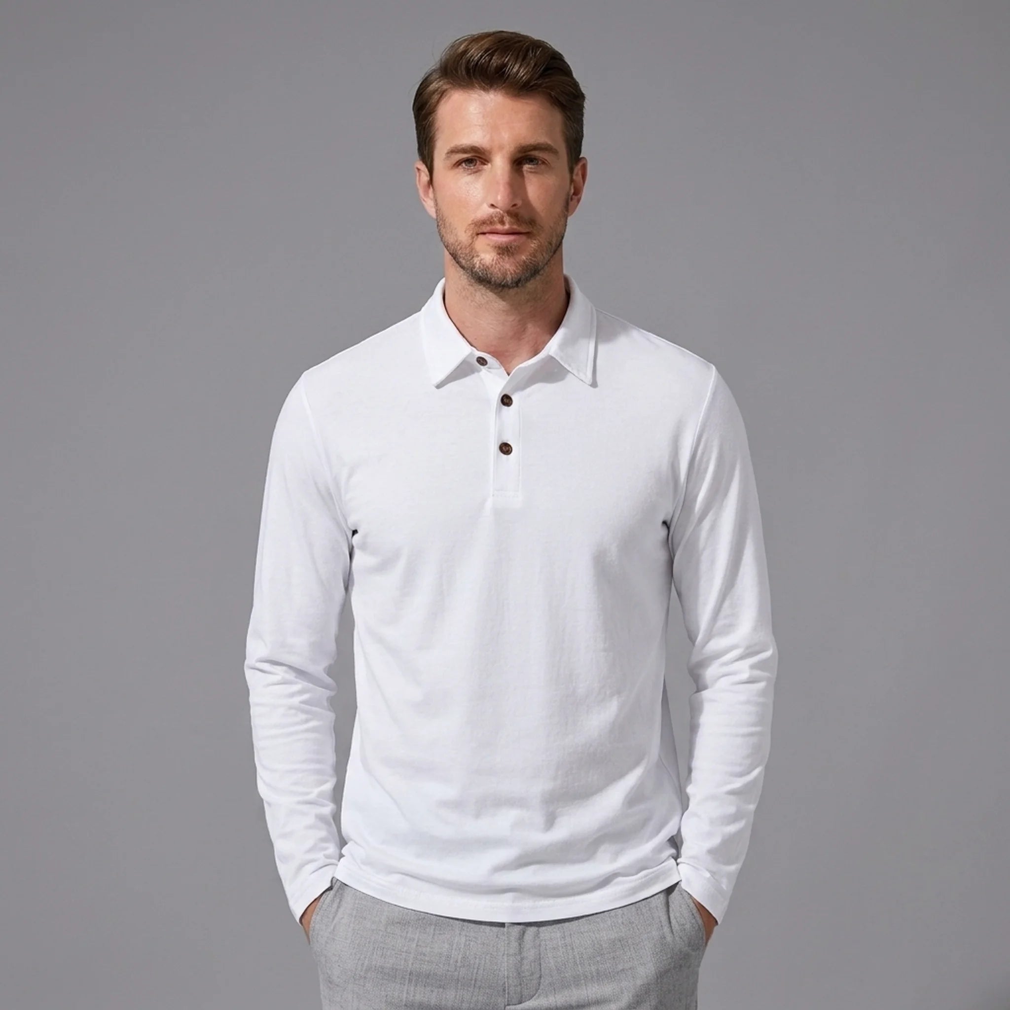 Man wearing white solid long sleeve cotton polo shirt with classic collar and dark buttons, front view