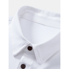Man wearing black solid long sleeve cotton polo shirt in outdoor lifestyle setting
