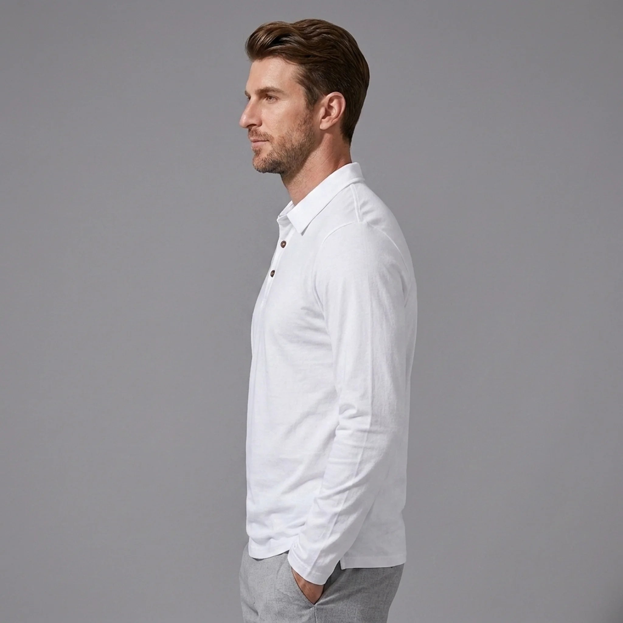 Side view of man wearing white solid long sleeve cotton polo shirt with classic collar