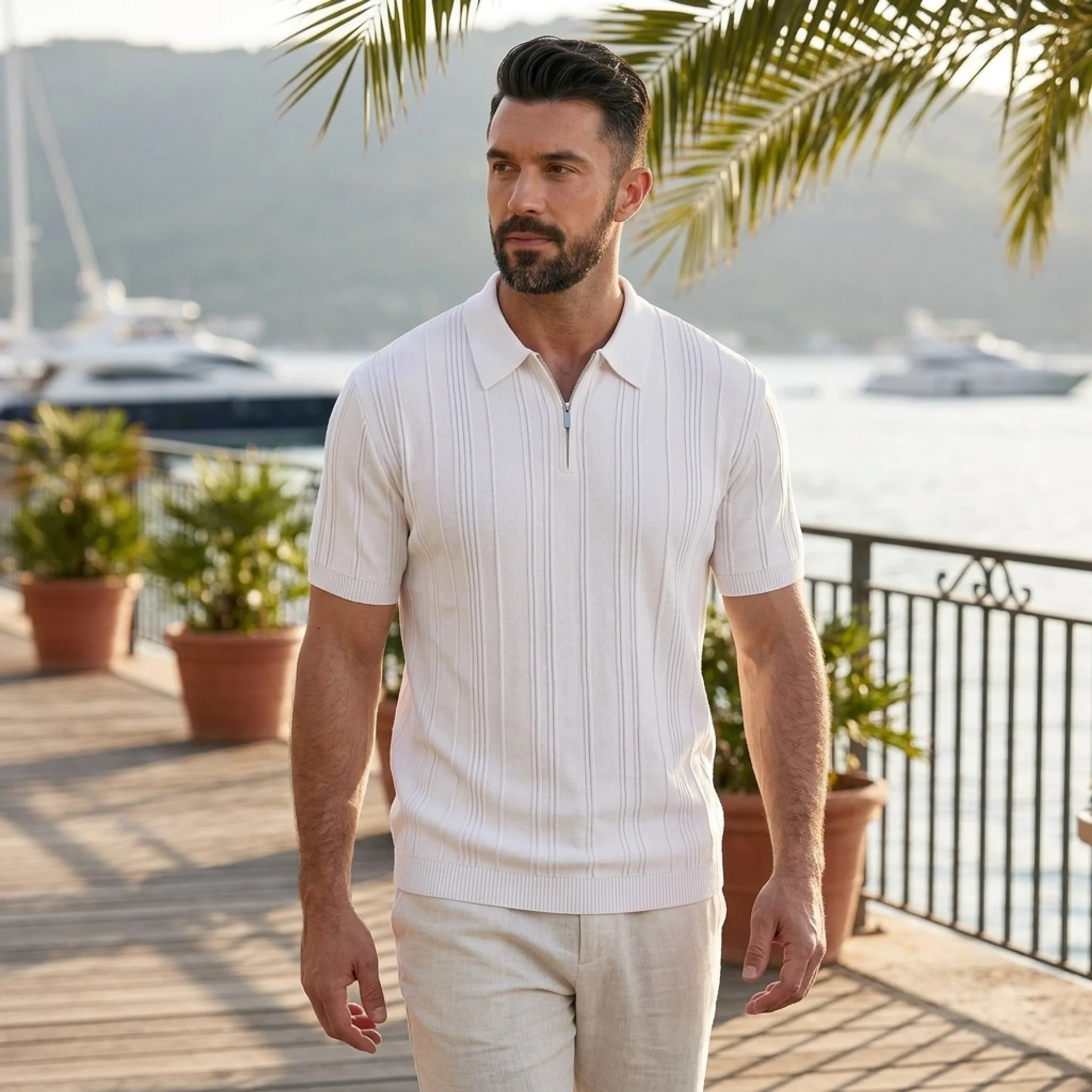 Man wearing white stripe jacquard knit zip-up polo shirt in outdoor lifestyle setting