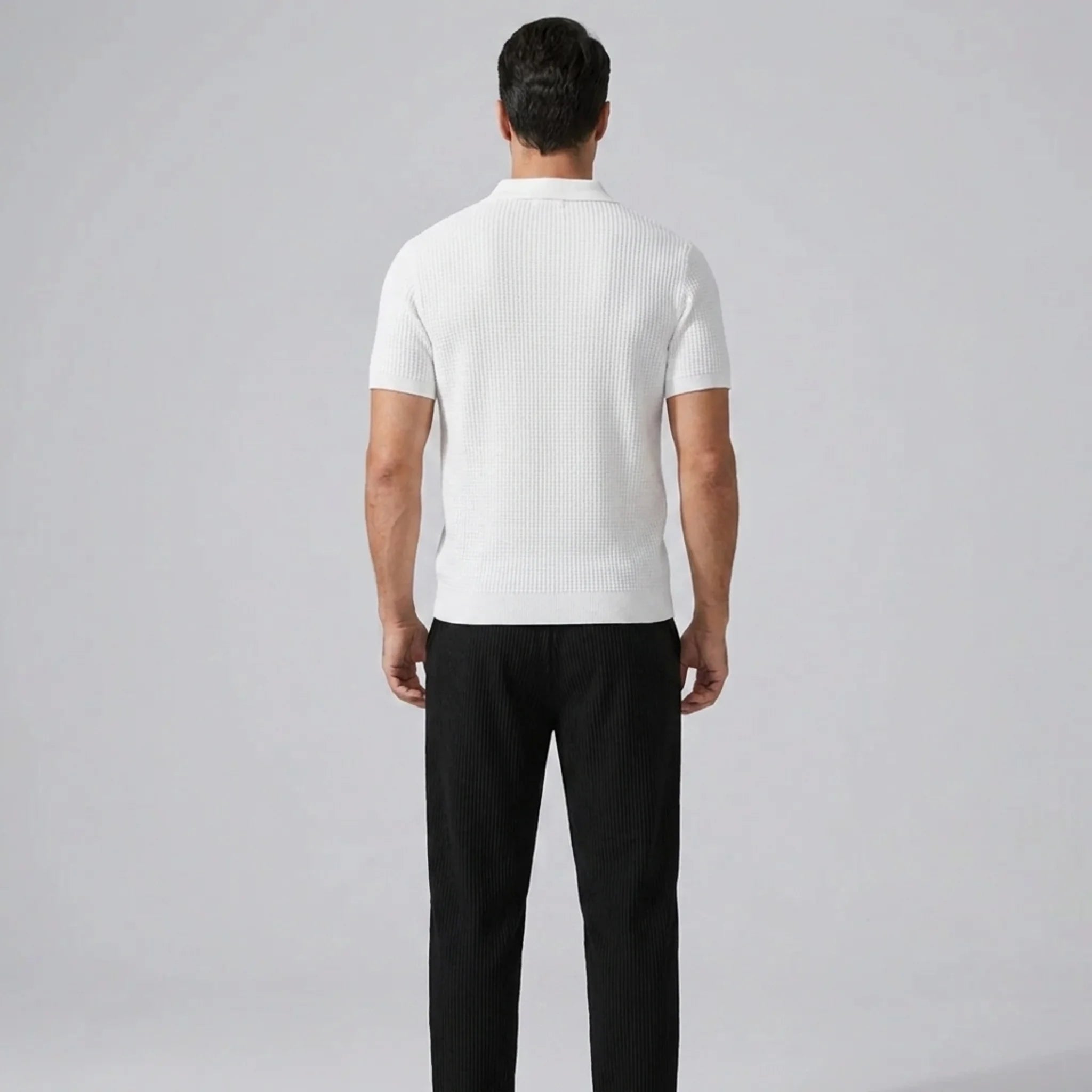 Back view of man in white striped knit Johnny collar polo and waffle drawstring pants