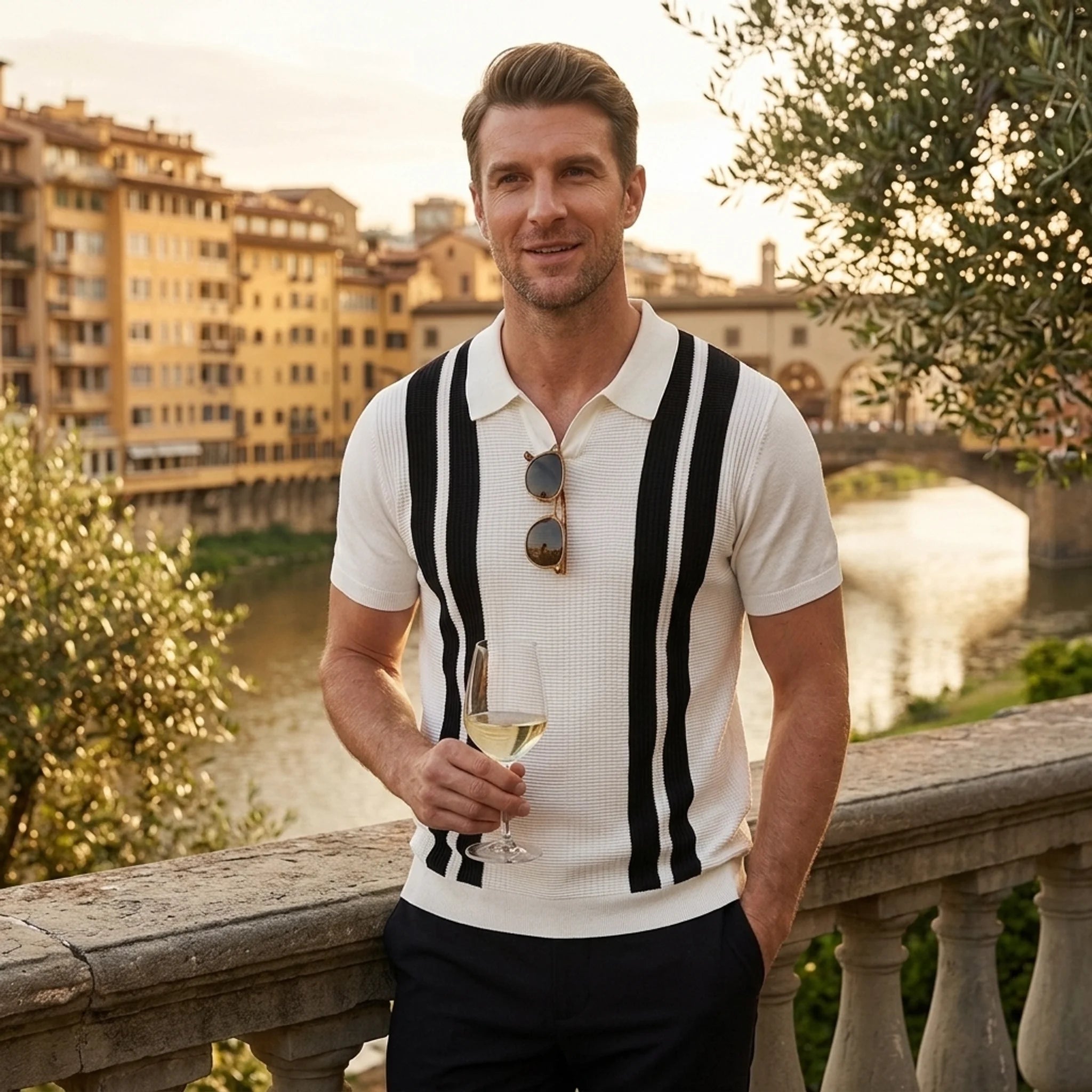 Man wearing white striped knit polo shirt in outdoor lifestyle setting