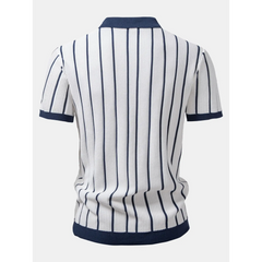 Side view of man in white striped knit button up shirt and straight leg linen pants on plain background