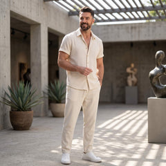 Man wearing white waffle button up shirt and linen pants in outdoor lifestyle setting