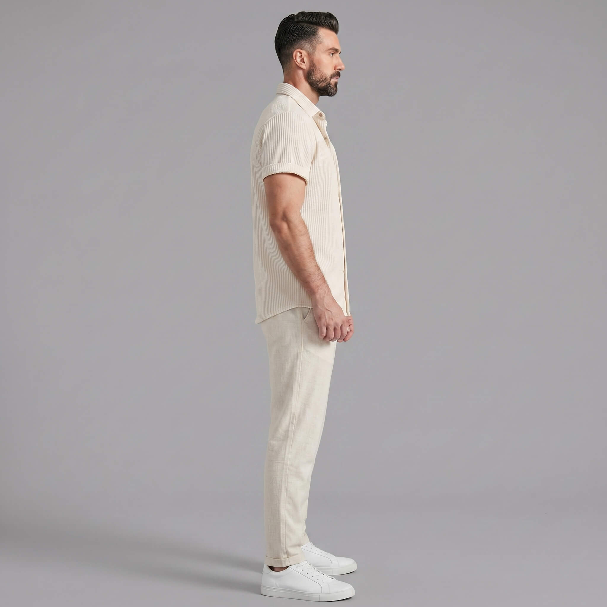Man wearing a white waffle button up shirt and straight leg linen pants front view on plain background
