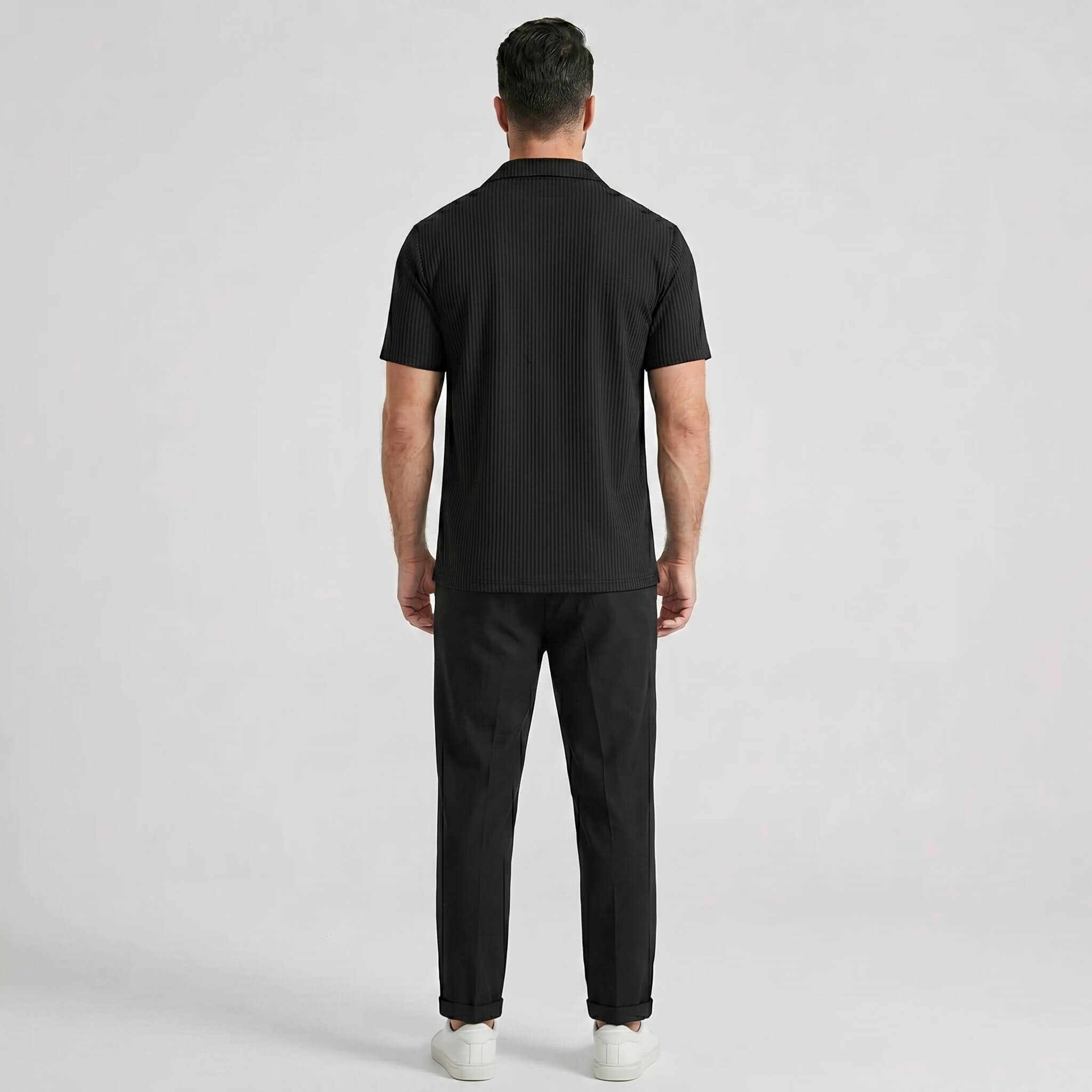 Side view of man in white waffle button up shirt and straight leg linen pants