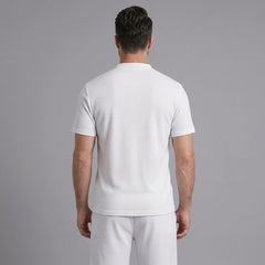 Back view of man wearing white waffle stand collar shirt and drawstring shorts