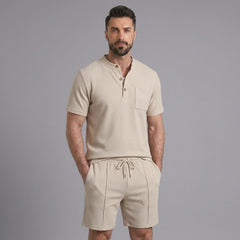 Man in white waffle stand collar shirt and drawstring shorts in sunny outdoor scene
