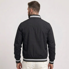 MannerCo black waterproof windbreaker jacket back view with striped collar and cuffs