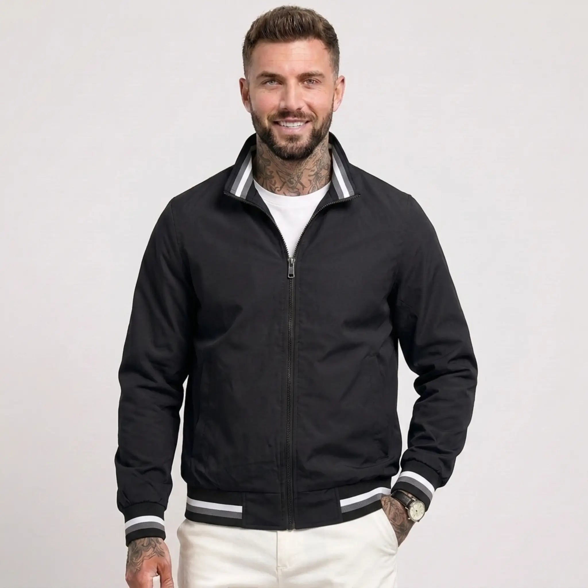 Man wearing MannerCo black waterproof windbreaker jacket with stand collar, front view