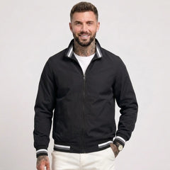 Man wearing MannerCo black waterproof windbreaker jacket with stand collar, front view