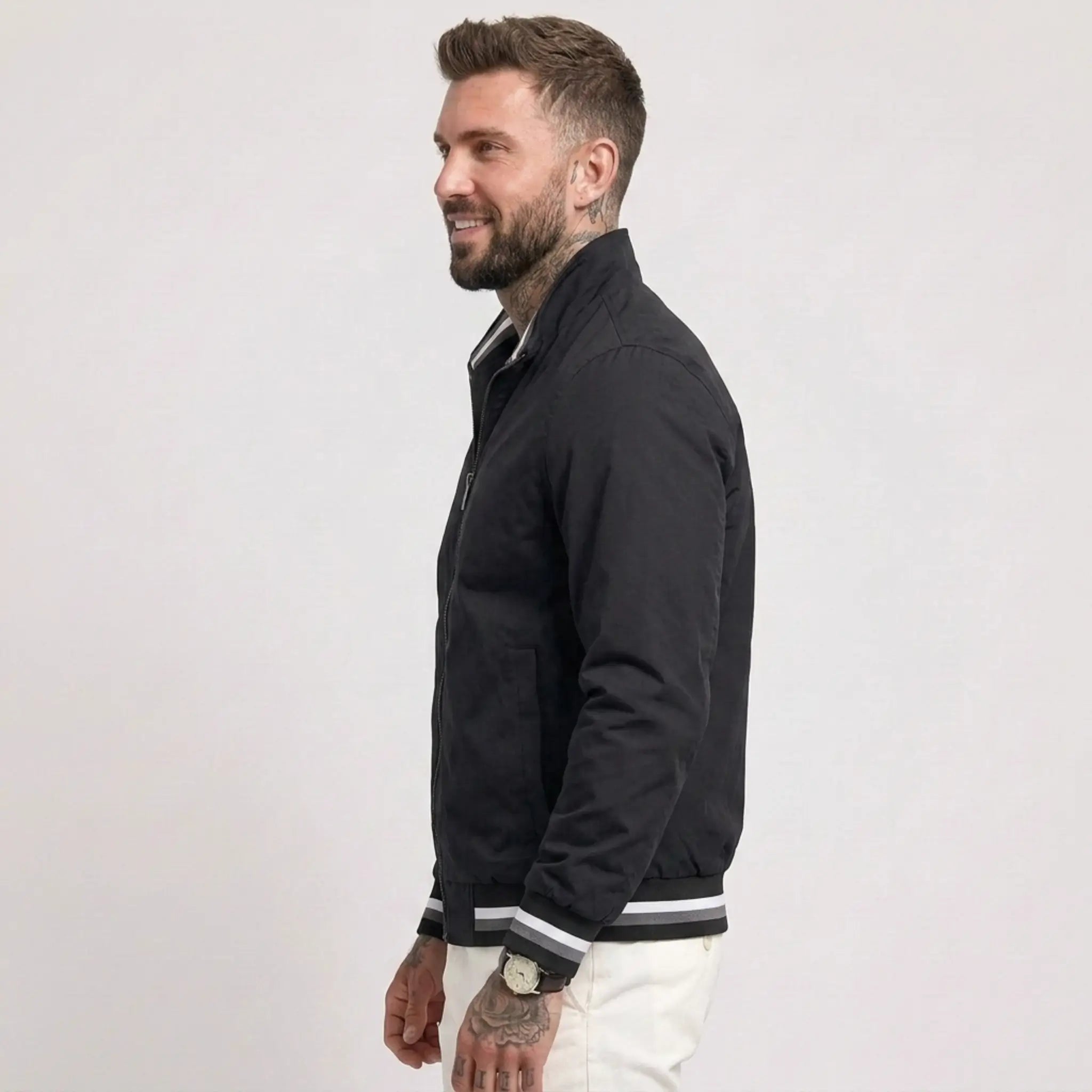 Man wearing MannerCo black waterproof windbreaker jacket with stand collar, side view