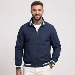 Man wearing MannerCo dark blue waterproof windbreaker jacket with stand collar, front view