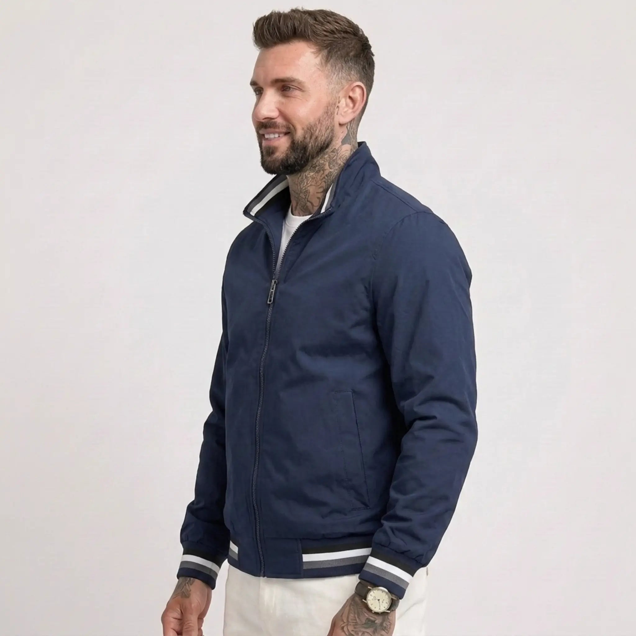 Man wearing MannerCo dark blue waterproof windbreaker jacket with stand collar, side view