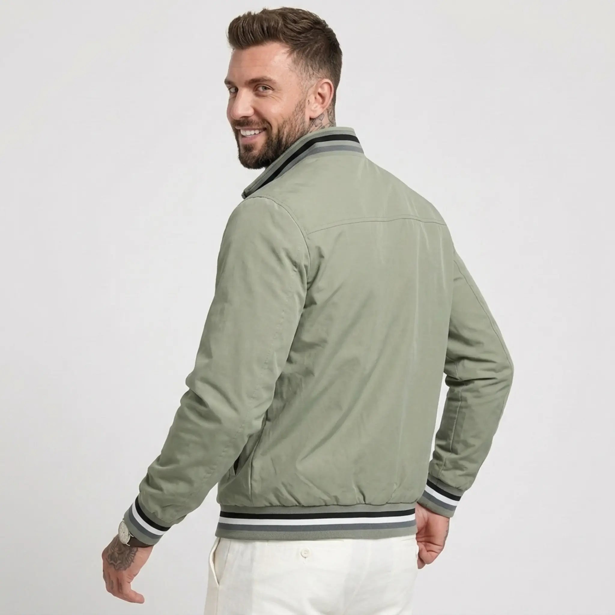 MannerCo green waterproof windbreaker jacket back view with striped collar and cuffs