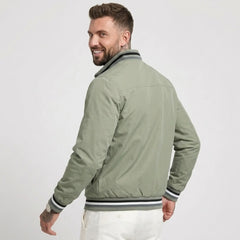 MannerCo green waterproof windbreaker jacket back view with striped collar and cuffs