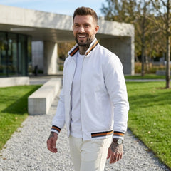 Man wearing MannerCo white waterproof windbreaker jacket in outdoor lifestyle setting