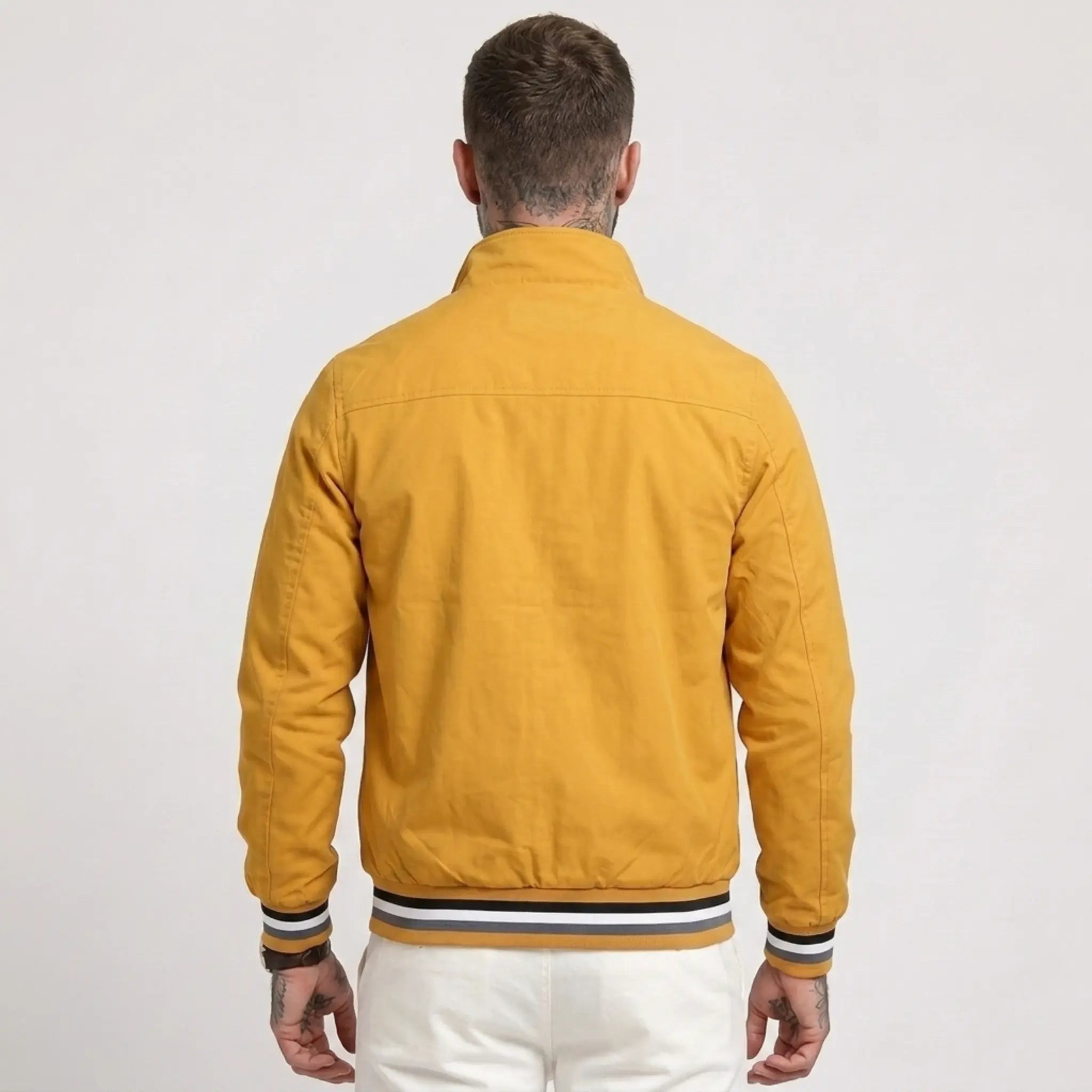 MannerCo yellow waterproof windbreaker jacket back view with striped collar and cuffs