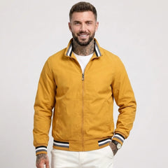 Man wearing MannerCo yellow waterproof windbreaker jacket with stand collar, front view