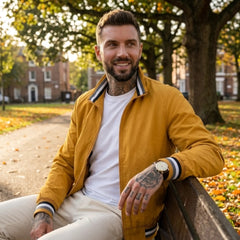 Man wearing MannerCo yellow waterproof windbreaker jacket in outdoor lifestyle setting