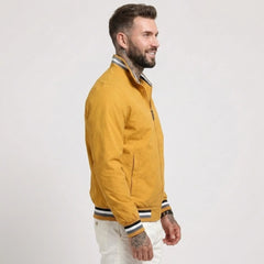 Man wearing MannerCo yellow waterproof windbreaker jacket with stand collar, side view