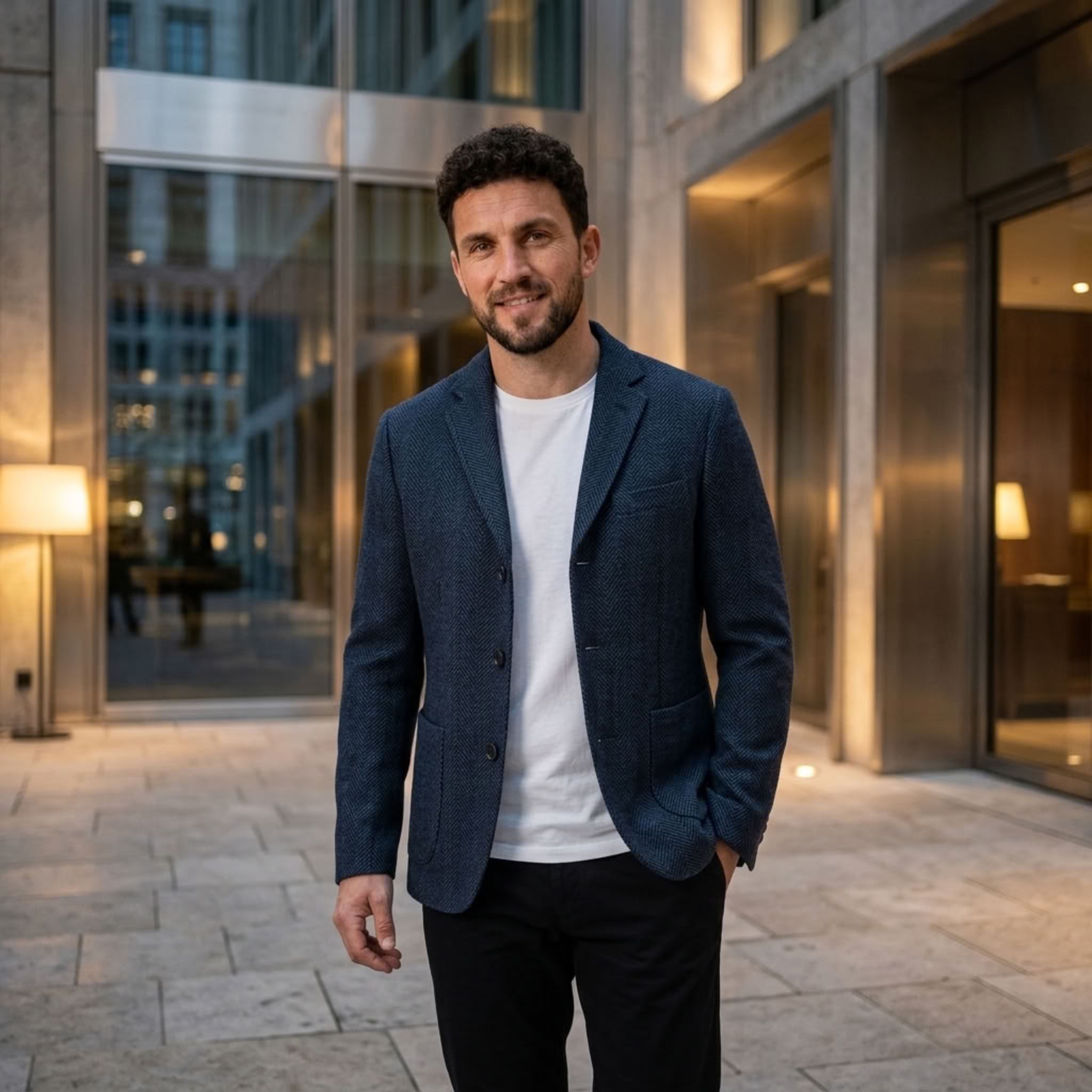 MannerCo dark blue woolen blazer relaxed fit worn over white tee outdoors
