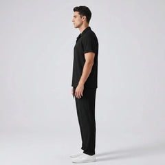 side view of man wearing a black polo shirt and trouser on a gray background