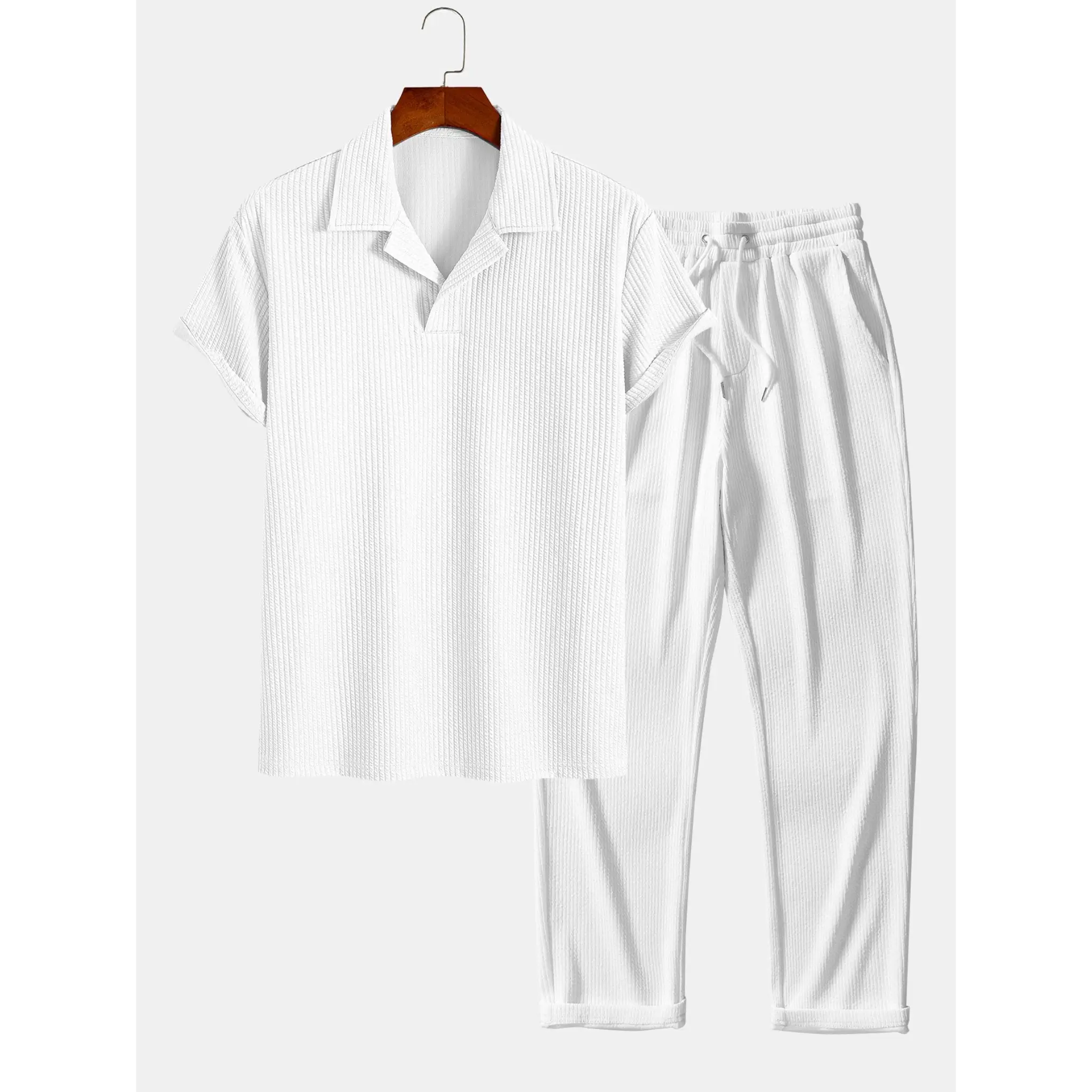 white polo shirt and trouser on hanger on white background