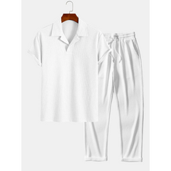 white polo shirt and trouser on hanger on white background